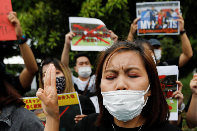 A woman shows three-finger salute during a rally of Myanmar protesters residing in Japan, outside the stadium before the Fifa World Cup Asia Qualifiers soccer match between Japan and Myanmar at Fukuda Denshi Arena in Chiba, east of Tokyo, on Friday. (Reuters photo) A woman shows three-finger salute during a rally of Myanmar protesters residing in Japan, outside the stadium before the Fifa World Cup Asia Qualifiers soccer match between Japan and Myanmar at Fukuda Denshi Arena in Chiba, east of Tokyo, on Friday. (Reuters photo)