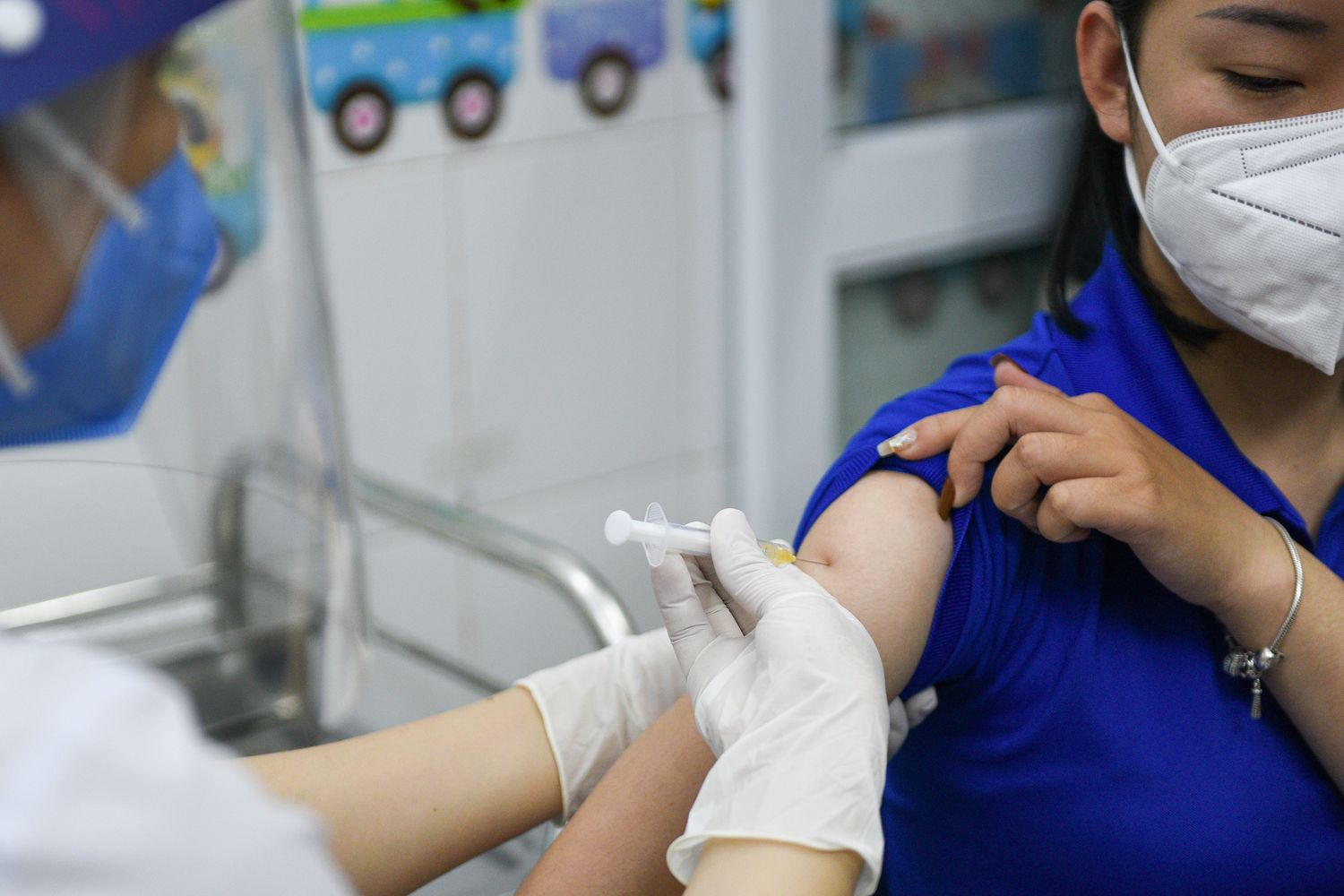 A woman receives a vaccine as Vietnam starts its official rollout of AstraZeneca's coronavirus disease vaccine for health workers at Hai Duong Hospital for Tropical Diseases, Hai Duong province, on March 8. (Reuters photo) A woman receives a vaccine as Vietnam starts its official rollout of AstraZeneca's coronavirus disease vaccine for health workers at Hai Duong Hospital for Tropical Diseases, Hai Duong province, on March 8. (Reuters photo)