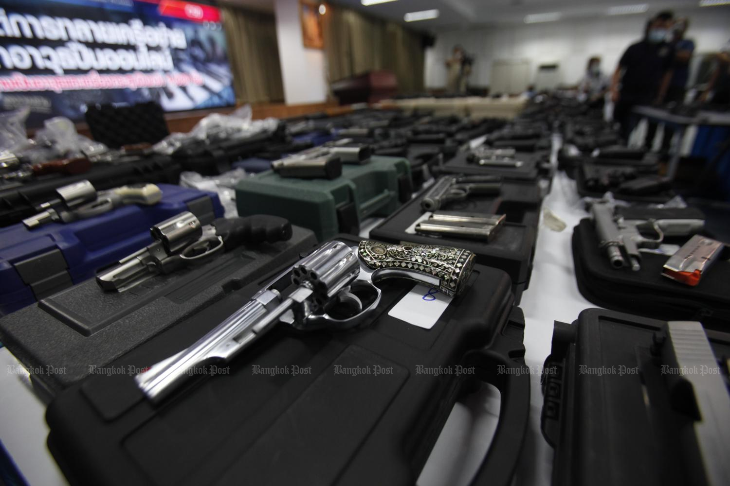 Pistols and revolvers seized in operations targeting the online illegal firearms trade are displayed at a press briefing. (Photo by Nutthawat Wichieanbut)