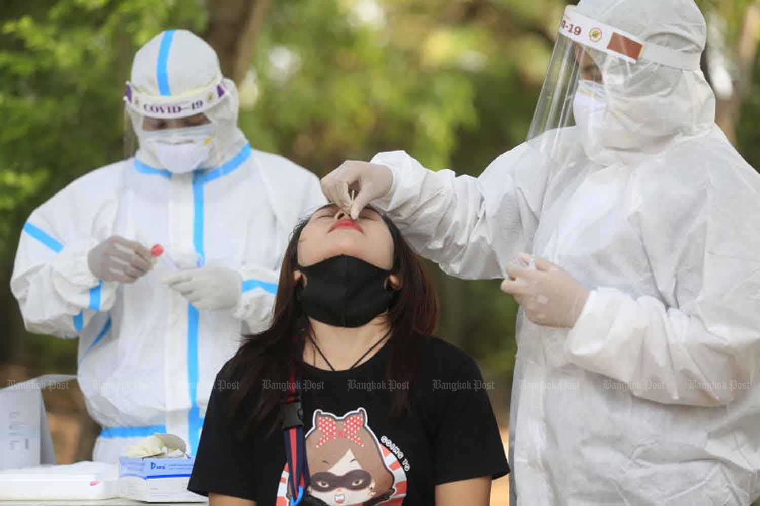 Health workers collect nasal swabs from people living and working near factories in Bang Khunthian district, Bangkok. Covid-19 is spreading "relentlessly" in factories, health officials said on Wednesday. (Photo: Pornprom Satrabhaya)