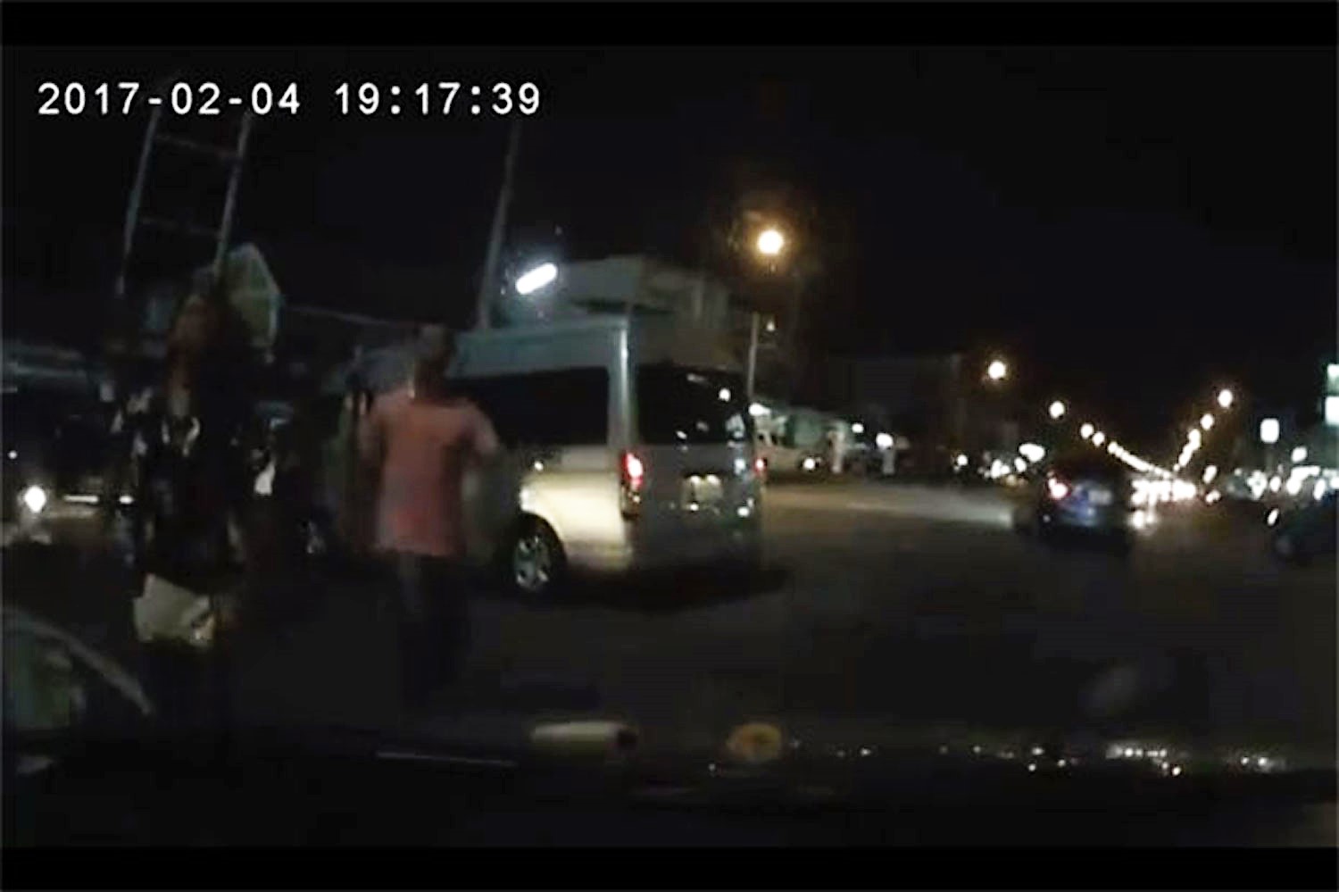 A picture taken from a dashcam video shows a youth from the van approaching engineer Suthep Phochanasomboon's car, seconds before the fatal shooting, in Chon Buri province on Feb 4 2017. A picture taken from a dashcam video shows a youth from the van approaching engineer Suthep Phochanasomboon's car, seconds before the fatal shooting, in Chon Buri province on Feb 4 2017.