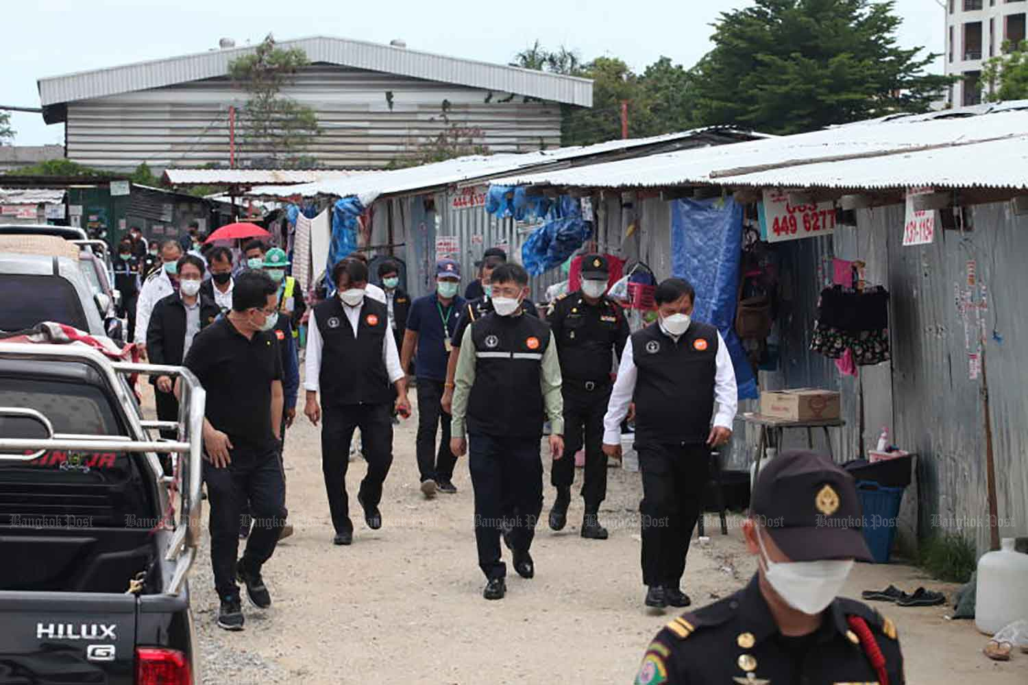 Officials of the Bangkok Metropolitan Administration inspect Covid-19 control measures at a construction workers’ camp in Lat Krabang district on Thursday. (Photo: Apichart Jinakul)