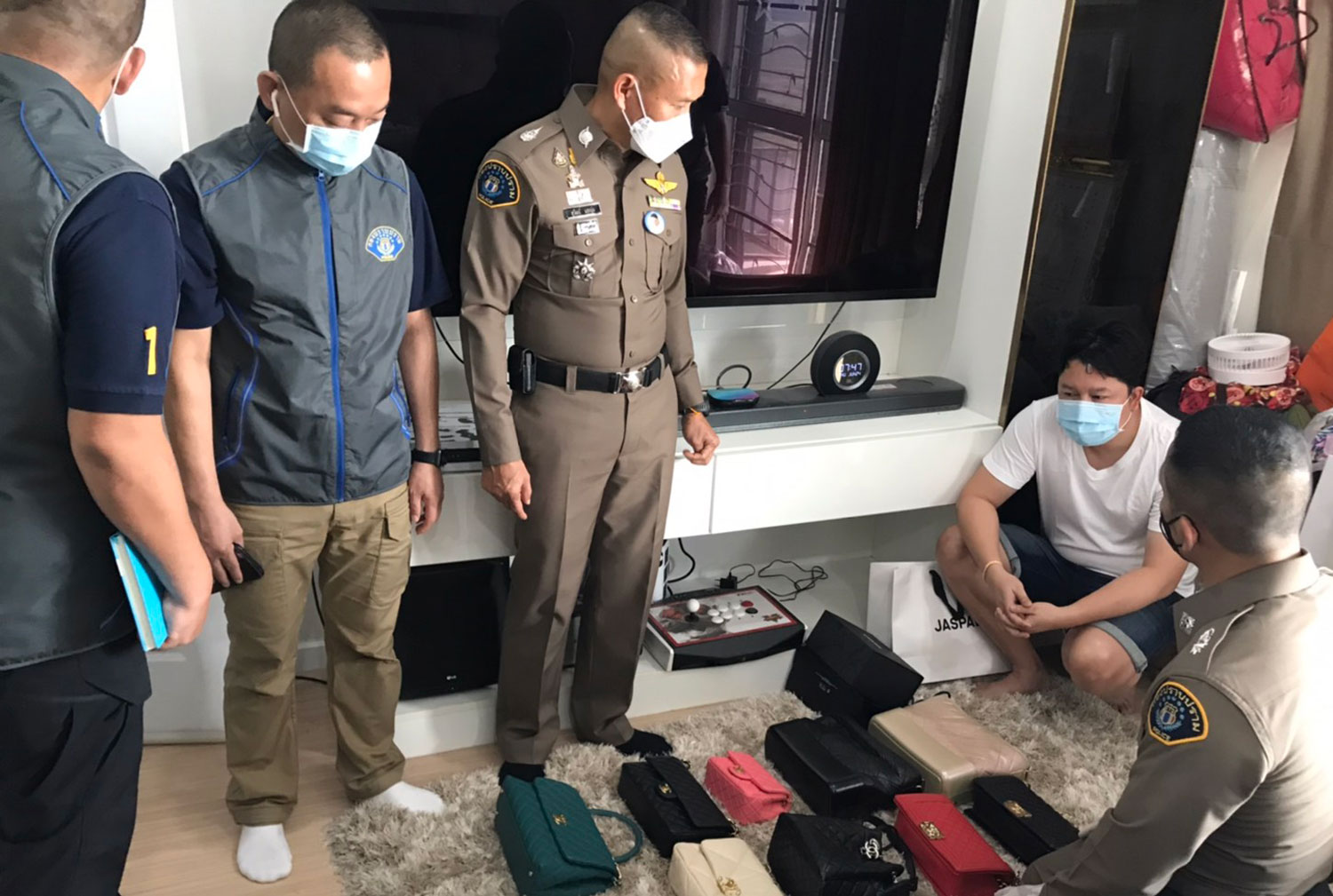 Naret Chamnong, 43, a former employee of a major mobile phone operator, is caught during a raid on his house in Saraburi by Crime Suppression Division police on Thursday morning. (Crime Suppression Division photo)