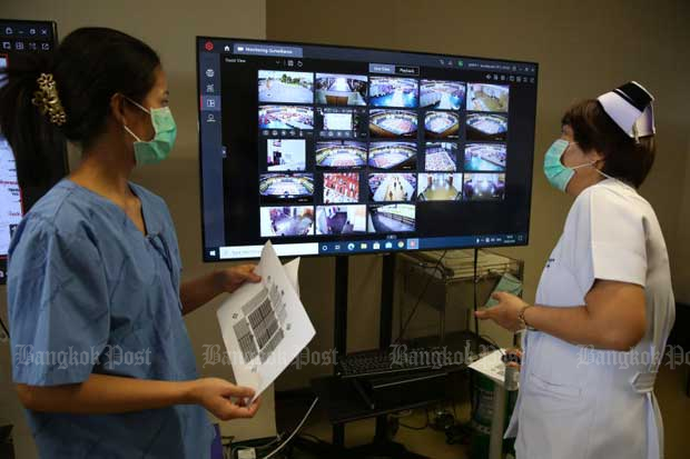 A nurse checks patients on a monitor screen at Erawan 2 field hospital in Nong Chok district of Bangkok on June 16, 2021. (Photo by Varuth Hirunyatheb)