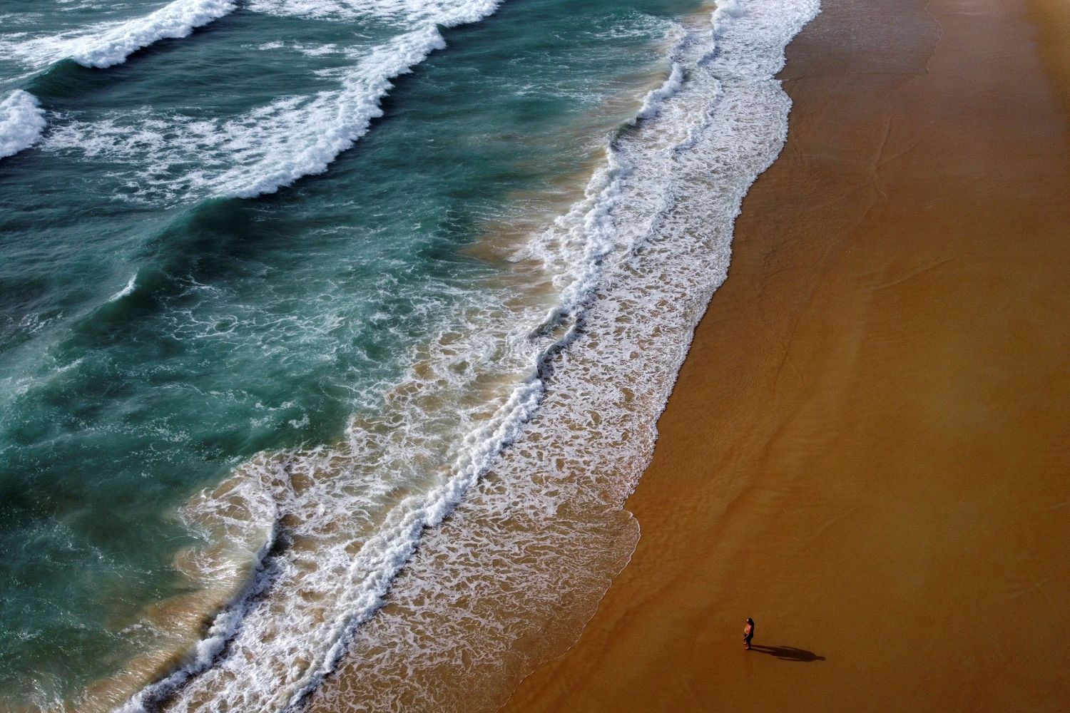 A man walks at the empty Karon beach in Phuket. Picture was taken on April 1 this year with a drone. (Reuters photo)