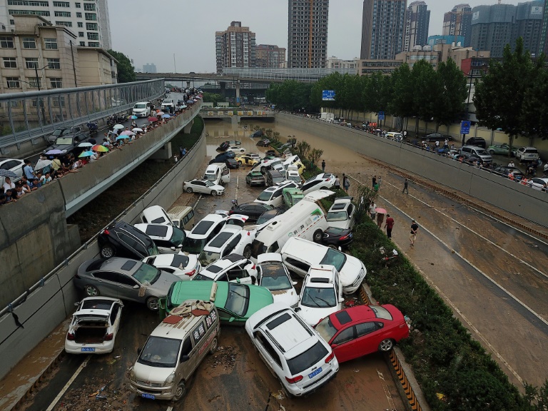 Cars were left strewn over roads after heavy rain hit the city of Zhengzhou. Cars were left strewn over roads after heavy rain hit the city of Zhengzhou.