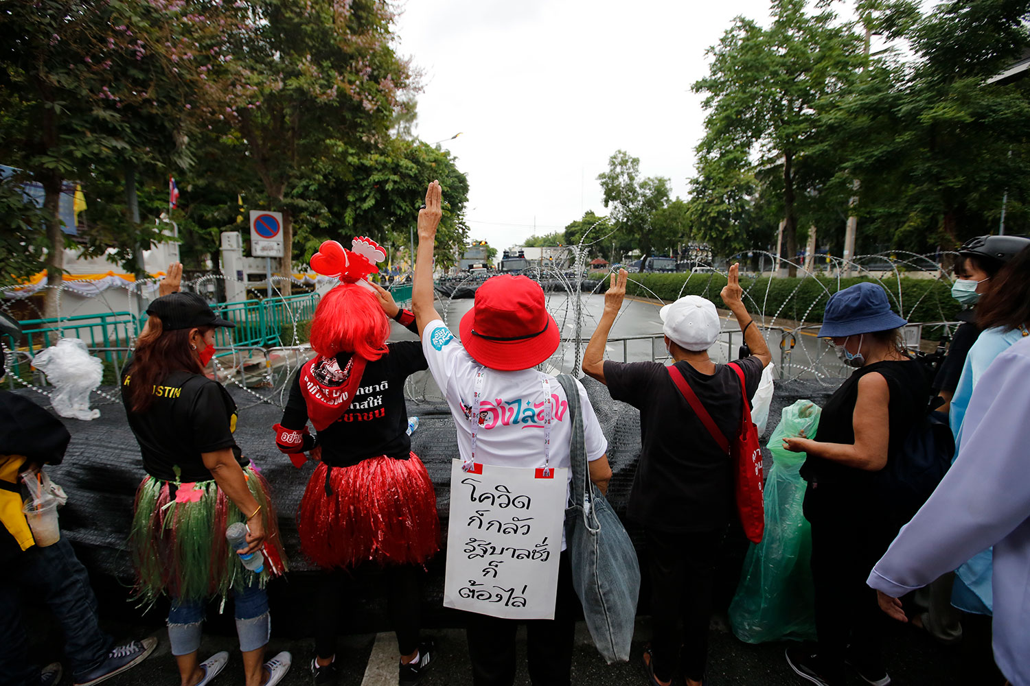 Protesters flash a three-finger salute during an anti-government rally on Sunday. (Bangkok Post photo)