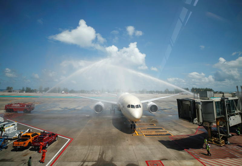 A plane carrying the first foreign tourists to Phuket after it reopened to overseas tourists receives a water cannon salute from fire trucks at the airport on July 1, 2021. (Reuters photo)