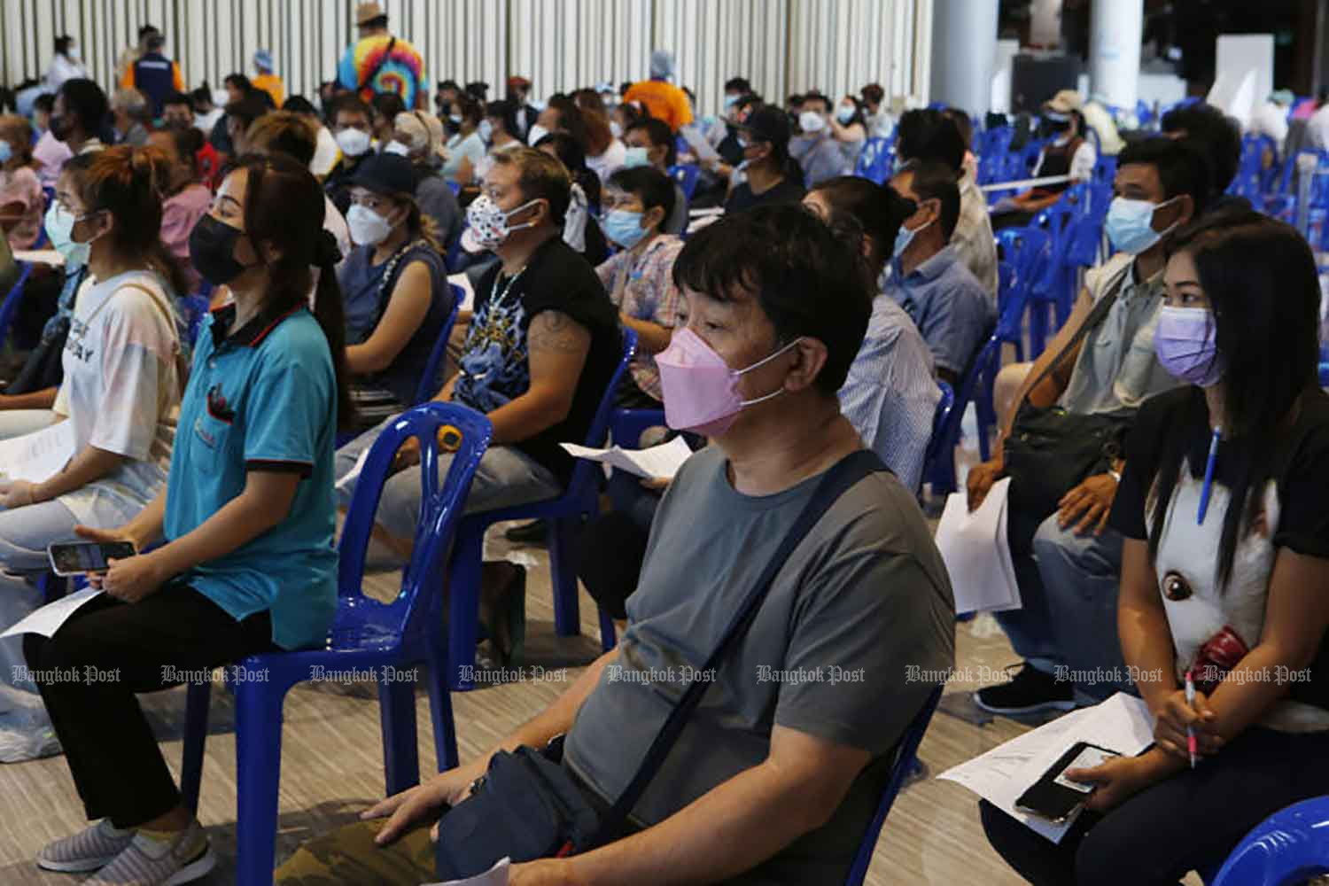 People are waiting for Covid-19 vaccinations at Future Park Rangsit shopping centre in Pathum Thani province on Monday. (Photo: Apichit Jinakul)