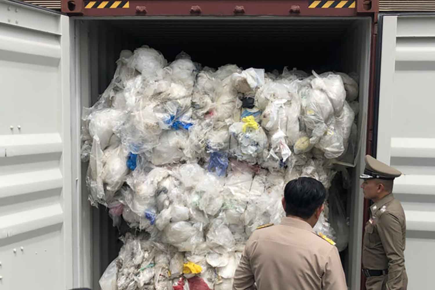 Officials inspect smuggled plastic waste in the cargo container imported from the United States, in Lat Krabang district of Bangkok in 2018. (Police photo)