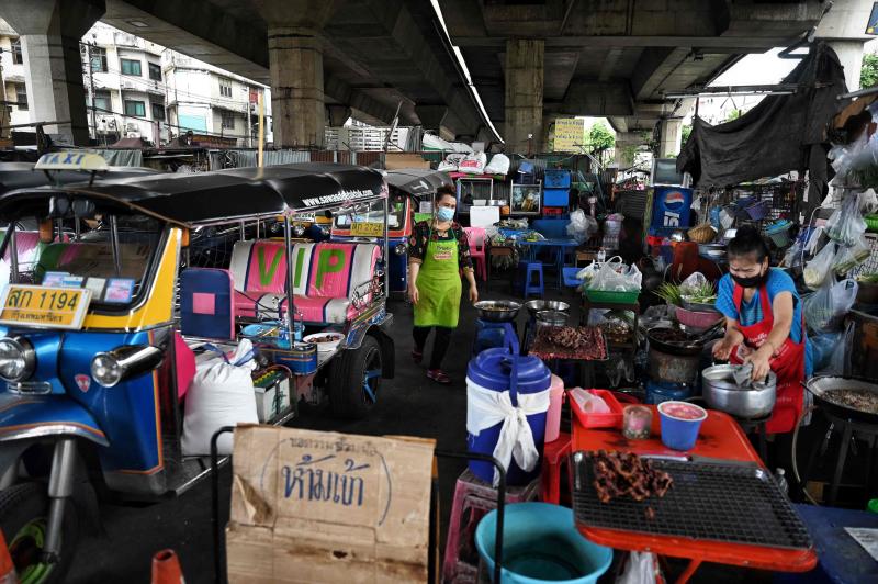 FILE PHOTO: People cook near rows of FILE PHOTO: People cook near rows of