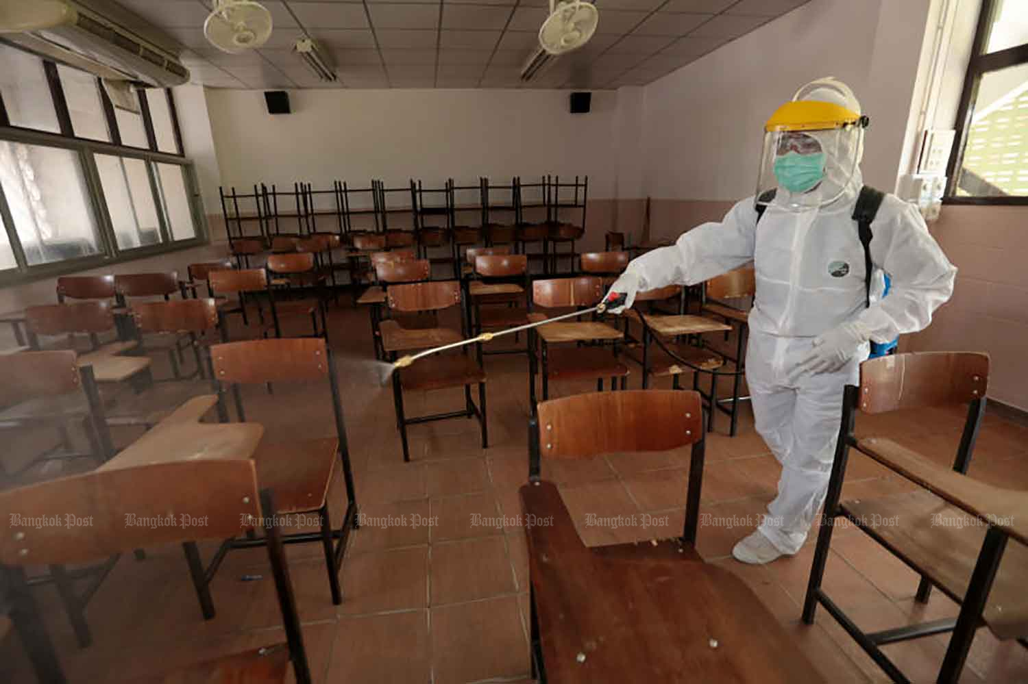 A classroom is sprayed with disinfectant at a Bangkok school closed for Covid-19 control. (Bangkok Post file photo)