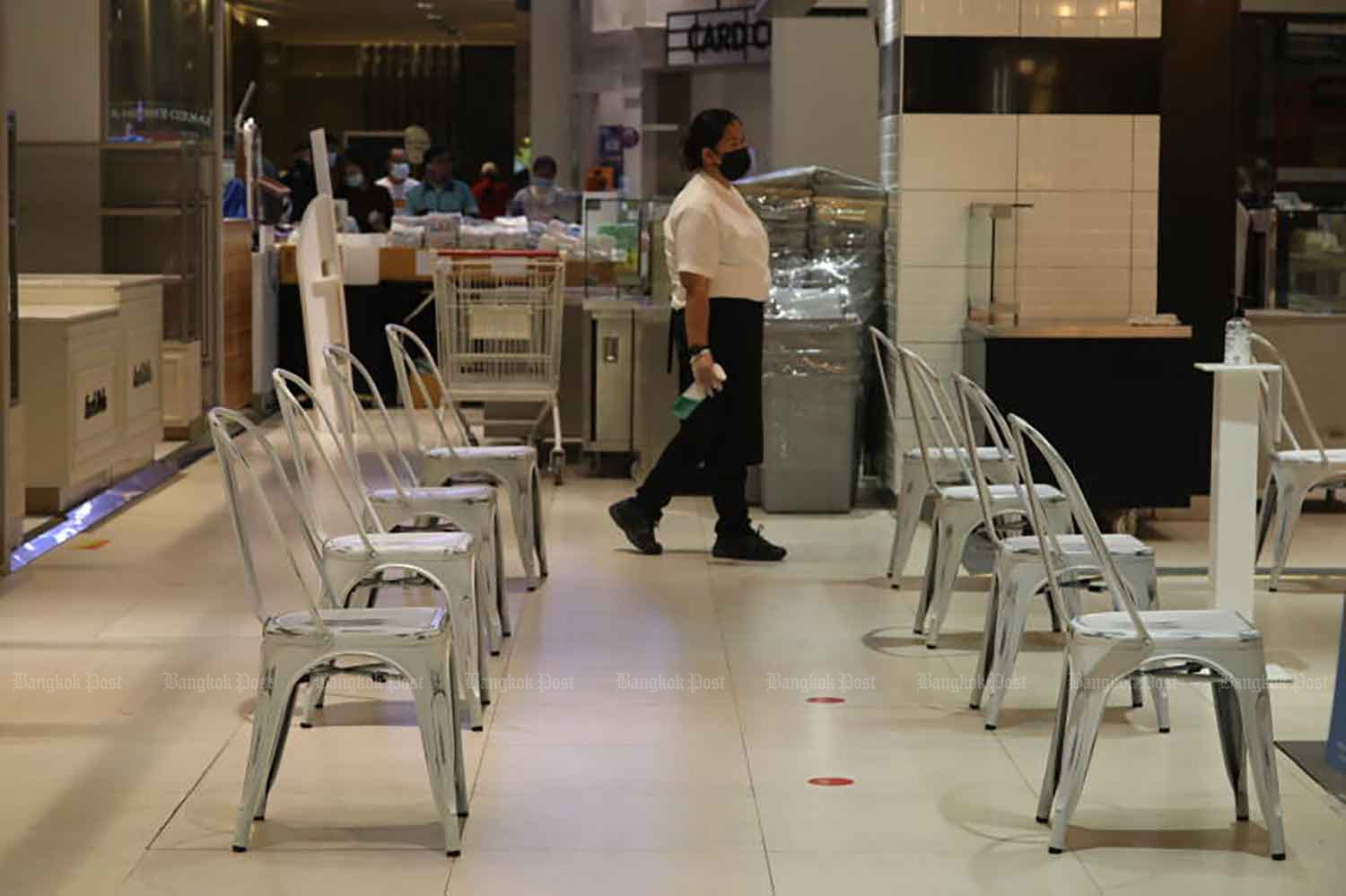 Chairs arranged for customers waiting for takeaways at a shopping centre food court in Bangkok. From Sept 1, the government will allow eateries to reopen for dining-in with strict Covid-19 controls. (Photo: Arnun Chonmahatrakool)