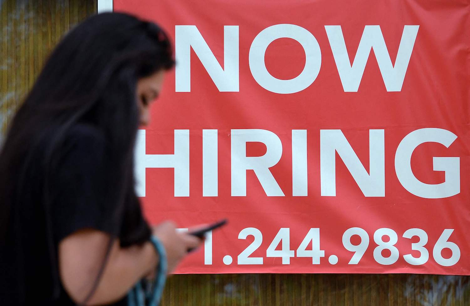 A woman walks by a “Now Hiring” sign outside a store in Arlington, Virginia in August. (AFP Photo) A woman walks by a “Now Hiring” sign outside a store in Arlington, Virginia in August. (AFP Photo)
