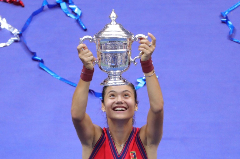Britain's Emma Raducanu celebrates with the US Open championship trophy after beating Canada's Leylah Fernandez in Saturday's final.