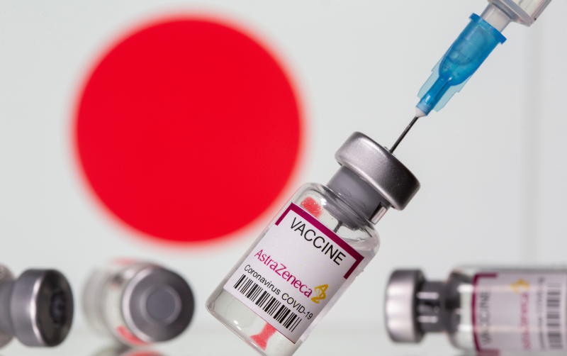 Vials labelled "Astra Zeneca COVID-19 Coronavirus Vaccine" and a syringe are seen in front of a displayed Japan flag, in this illustration photo taken March 14, 2021. (Reuters file pohto)