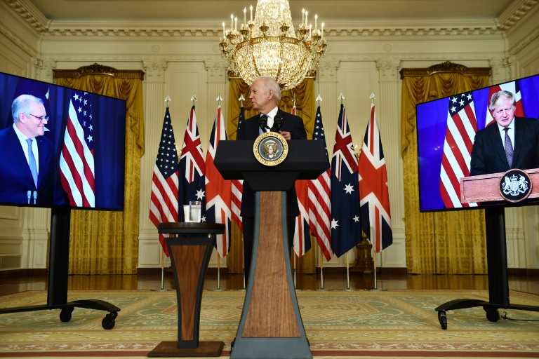 US President Joe Biden participates in a virtual press conference on national security with British Prime Minister Boris Johnson, right screen, and Australian Prime Minister Scott Morrison, left, from the East Room of the White House in Washington, DC. US President Joe Biden participates in a virtual press conference on national security with British Prime Minister Boris Johnson, right screen, and Australian Prime Minister Scott Morrison, left, from the East Room of the White House in Washington, DC.