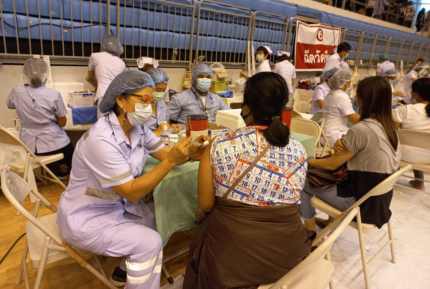 Nurses give Covid vaccine shots to people in Phuket as the island province reports five more Covid-19 deaths and 238 new infections. (Photo: Achadtaya Chuenniran)