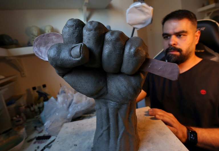 Kuwaiti artist Maitham Abdal works on his sculpture, Kuwaiti artist Maitham Abdal works on his sculpture,