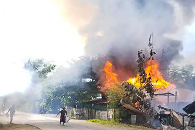 People attempt to extinguish a fire as houses burn in Namg Kar village in Magwe region's Gangaw township on Saturday, as fighting continues between the Myanmar military and protesters against the military coup. (AFP PHOTO / ANONYMOUS SOURCE) People attempt to extinguish a fire as houses burn in Namg Kar village in Magwe region's Gangaw township on Saturday, as fighting continues between the Myanmar military and protesters against the military coup. (AFP PHOTO / ANONYMOUS SOURCE)