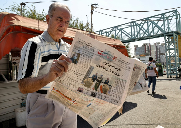 An Iranian man reads a copy of the daily newspaper An Iranian man reads a copy of the daily newspaper
