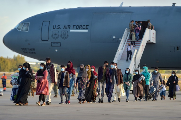 Refugees from Afghanistan disembark from a US air force aircraft at the Rota naval base in southern Spain, before heading to the United States. Refugees from Afghanistan disembark from a US air force aircraft at the Rota naval base in southern Spain, before heading to the United States.