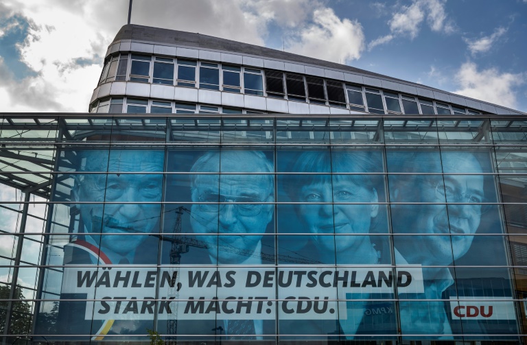 The CDU is portraying Armin Laschet (right) as the candidate to ensure continuity and cement Merkel's legacy The CDU is portraying Armin Laschet (right) as the candidate to ensure continuity and cement Merkel's legacy