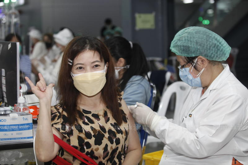 A woman receives a booster shot at a vaccination centre at Bang Sue Grand Station on Friday. (Photo: Nutthawat Wicheanbut)