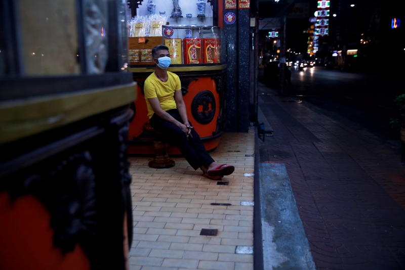 A man waits for customers in front of his shop at an almost empty road in Yaowarat which is usually crowded with people, as lockdown and travel restrictions are imposed to curb the spread of the coronavirus disease in Bangkok on July 12, 2021. (Reuters photo)