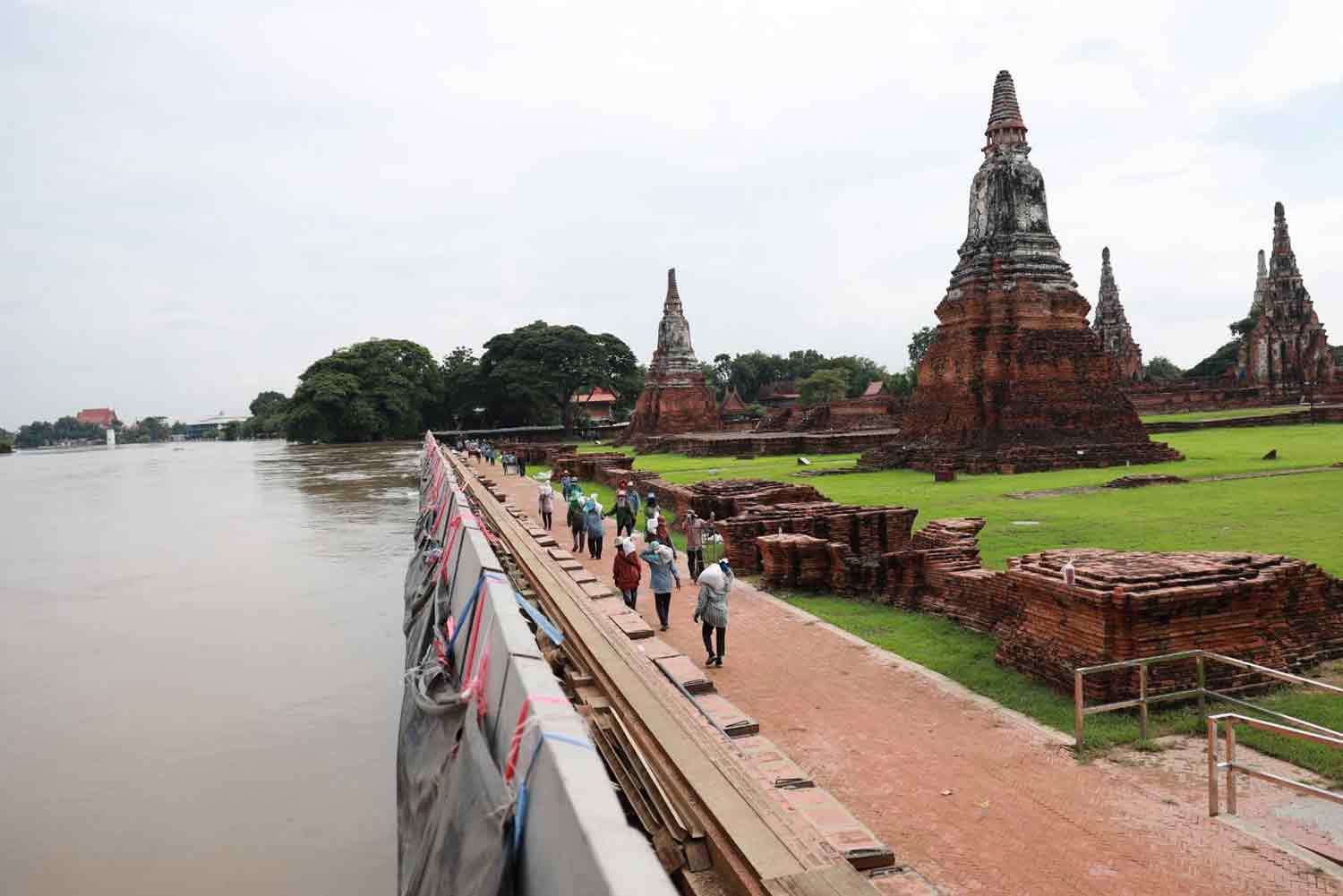 River floodwall built up at old temple