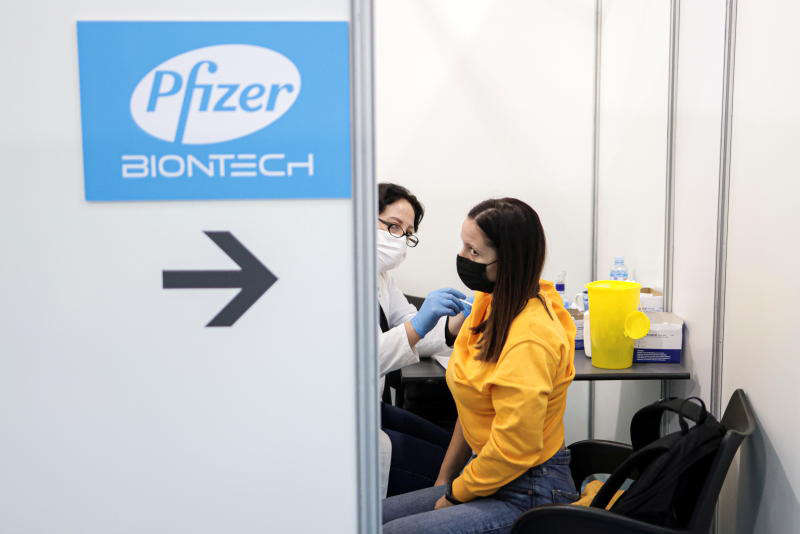 A healthcare worker administers a dose of the Pfizer vaccine to a woman at a vaccination centre in Belgrade, Serbia, on Friday. (Reuters photo) A healthcare worker administers a dose of the Pfizer vaccine to a woman at a vaccination centre in Belgrade, Serbia, on Friday. (Reuters photo)
