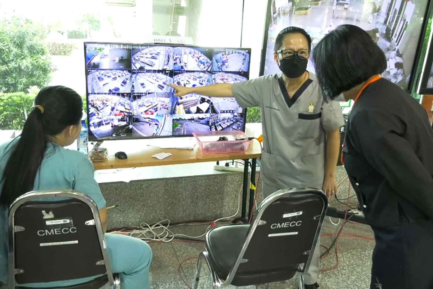 Health officials review the floor plan of the field hospital set up at the Chiang Mai International Exhibition and Convention Centre. (Photo: Panumet Tanraksa)