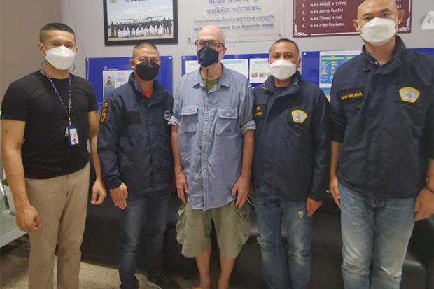 Fraud suspect Thomas Michael Grimm (centre) is flanked by officers at the police Economic Crime Division on Thursday. (Economic Crime Division photo)