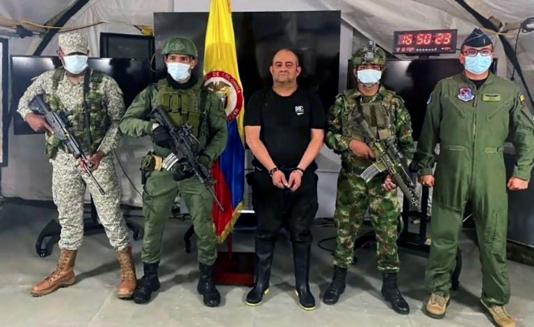 The Colombian Army's escort the country's most-wanted drug lord Dairo Antonio Usuga after his capture. The Colombian Army's escort the country's most-wanted drug lord Dairo Antonio Usuga after his capture.