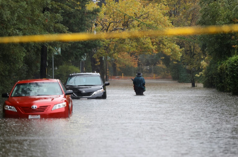 A pedestrian walks on a flooded street on October 24, 2021 in Kentfield, California A pedestrian walks on a flooded street on October 24, 2021 in Kentfield, California