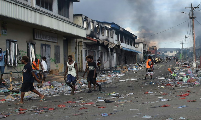 After days of unrest, large areas of the Solomon Islands' capital have been left with the scorched-black shells of buildings After days of unrest, large areas of the Solomon Islands' capital have been left with the scorched-black shells of buildings