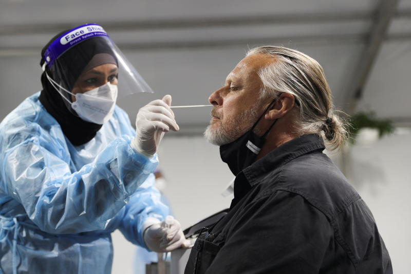 A traveller receives a test for the coronavirus at a pre-departure testing facility at Sydney Airport in Sydney on Monday. (Reuters photo) A traveller receives a test for the coronavirus at a pre-departure testing facility at Sydney Airport in Sydney on Monday. (Reuters photo)