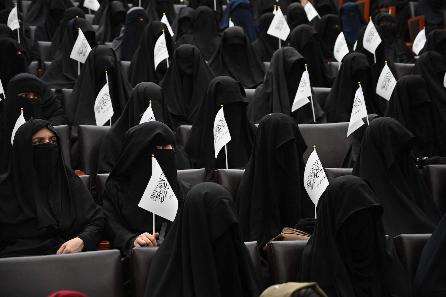Veiled students hold Taliban flags as they listen to women speakers before a pro-Taliban rally at the Shaheed Rabbani Education University in Kabul in September. (AFP Photo) Veiled students hold Taliban flags as they listen to women speakers before a pro-Taliban rally at the Shaheed Rabbani Education University in Kabul in September. (AFP Photo)