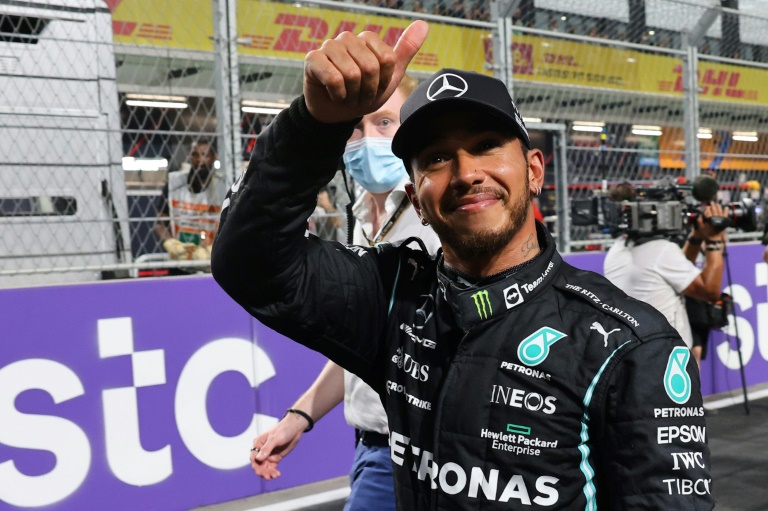 Thumbs up: Lewis Hamilton celebrates his pole position