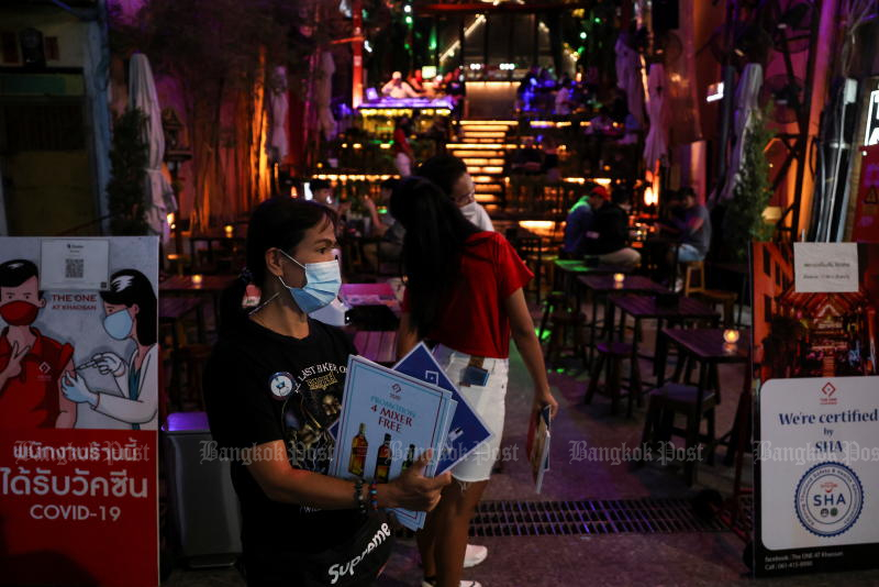 FILE PHOTO: A restaurant worker stands next to notices saying staff have been vaccinated against Covid-19 on Bangkok's Khaosan Road on Nov 30, 2021. Thailand confirmed three cases of the Omicron variant on Thursday. (Reuters) FILE PHOTO: A restaurant worker stands next to notices saying staff have been vaccinated against Covid-19 on Bangkok's Khaosan Road on Nov 30, 2021. Thailand confirmed three cases of the Omicron variant on Thursday. (Reuters)