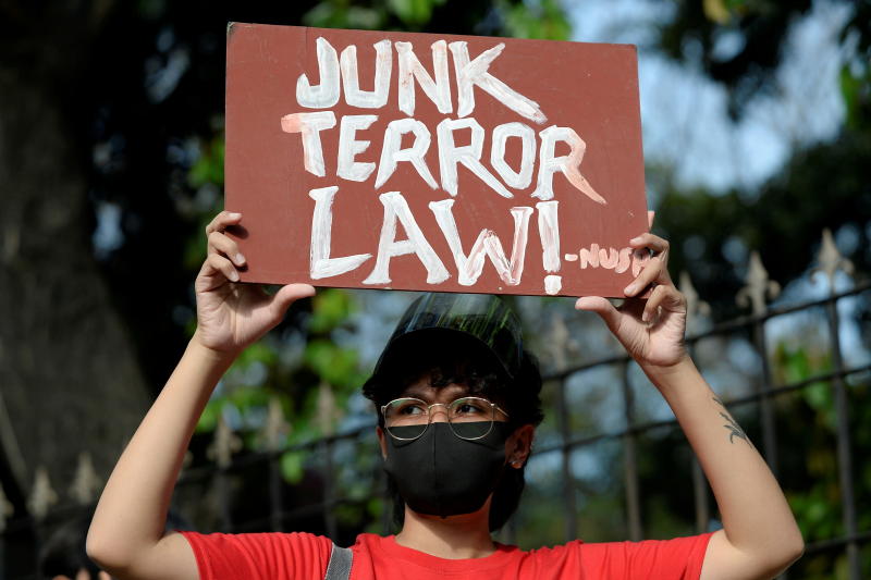 FILE PHOTO: An activist holds a placard at a protest a few hours before the start of the hearing of oral arguments on the anti-terrorism law, in front of the Philippine General Hospital, in Manila, Philippines, Feb 2, 2021. (Reuters) FILE PHOTO: An activist holds a placard at a protest a few hours before the start of the hearing of oral arguments on the anti-terrorism law, in front of the Philippine General Hospital, in Manila, Philippines, Feb 2, 2021. (Reuters)