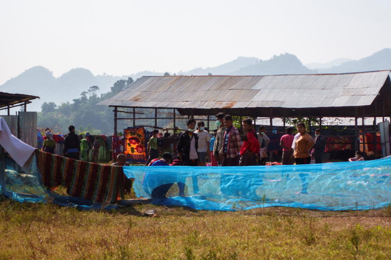 Refugees, who fled a flare-up in fighting between the Myanmar army and ethnic minority rebels, stand at a temporary shelter in Mae Sot district, Tak, on Monday. (Reuters photo)