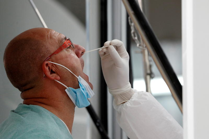 A man is tested as a mandatory measure for arriving passengers to prevent the spread of the coronavirus disease at Phuket airport on Nov 29, 2021. (Reuters photo)