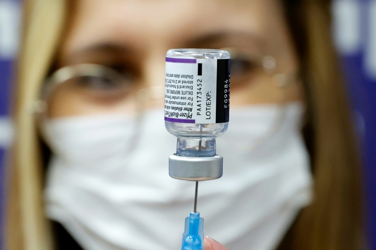 A medic prepares a dose of Pfizer vaccine to be used as a fourth shot at Sheba Medical Center in Ramat Gan, near Tel Aviv in December 2021. A medic prepares a dose of Pfizer vaccine to be used as a fourth shot at Sheba Medical Center in Ramat Gan, near Tel Aviv in December 2021.