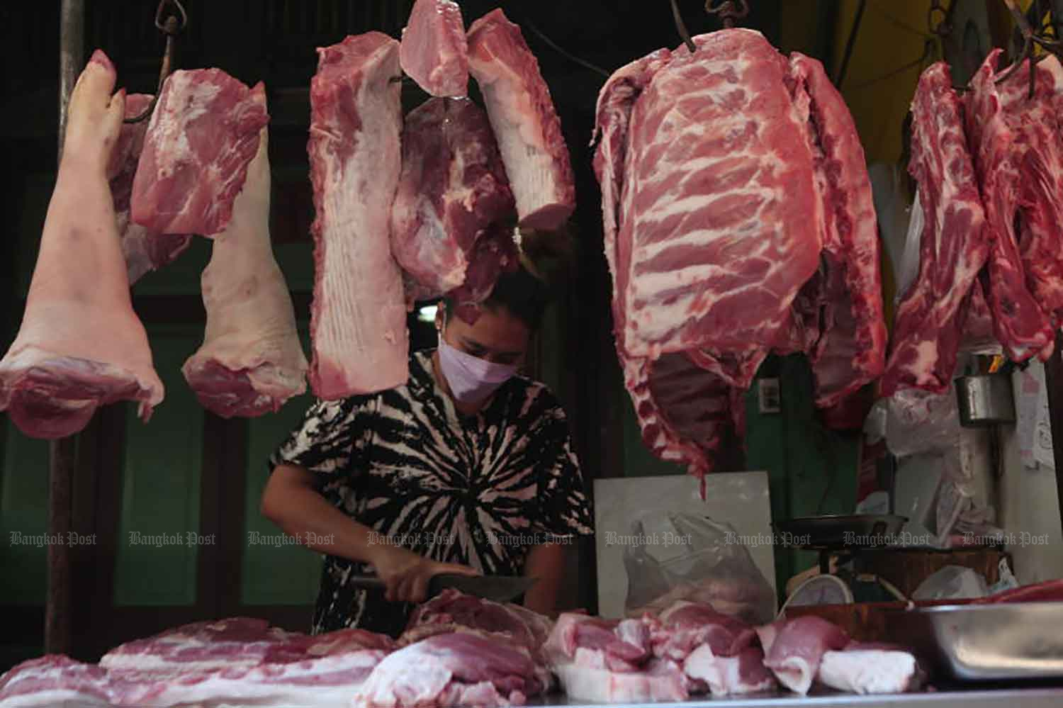 A pork vendor works at her stall at Yaowarat market, Bangkok, earlier this month. (Photo: Apichart Jinakul)