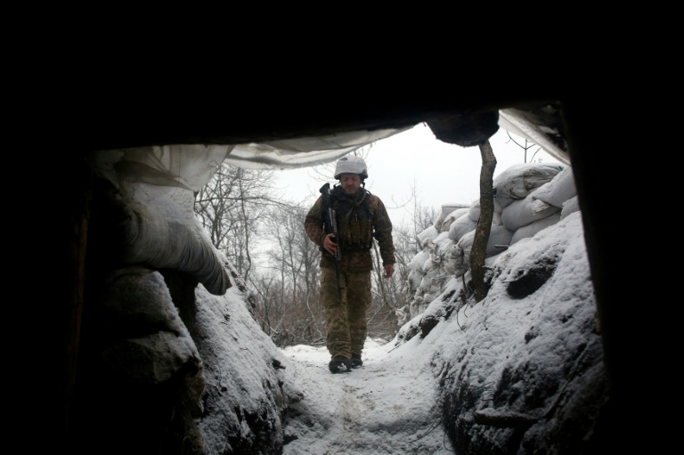 An Ukrainian Military Forces serviceman walks along a snow covered trench on the frontline with the Russia-backed separatists near Zolote village, in the eastern Lugansk region, on January 21, 2022. An Ukrainian Military Forces serviceman walks along a snow covered trench on the frontline with the Russia-backed separatists near Zolote village, in the eastern Lugansk region, on January 21, 2022.