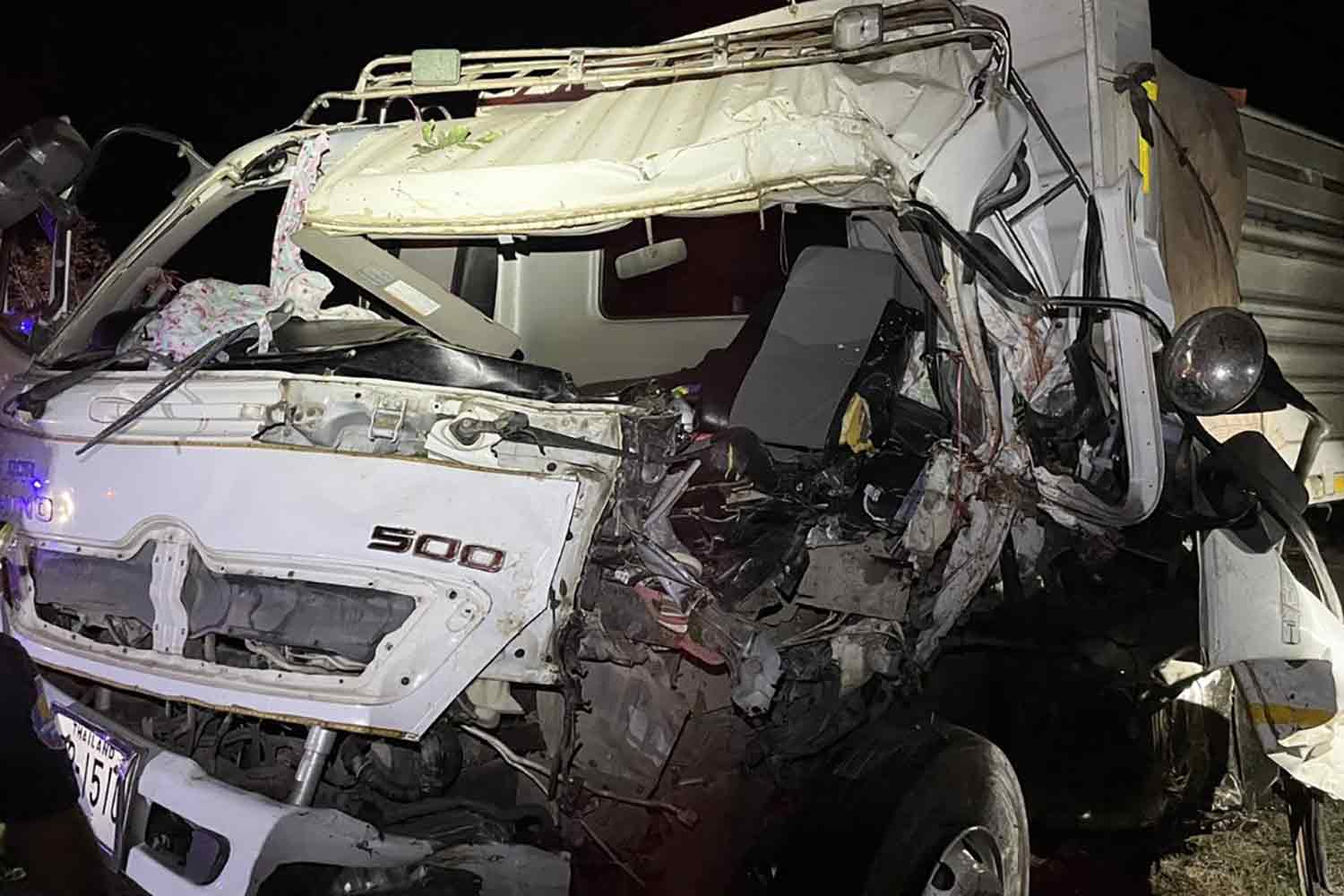 The caved-in cab of the trailer truck after it hit a roadside tree and power pole in Surin's Prasat district on Monday night. The woman passenger died in the crash. (Photo: Nopparat Kingkaew)