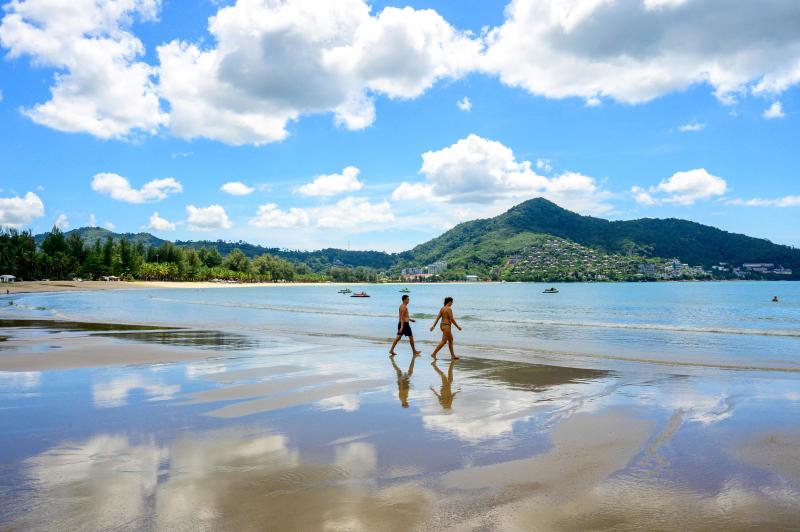 Tourists walk on a beach on the Thai island of Phuket on Nov 2, 2021. (Photo: AFP)