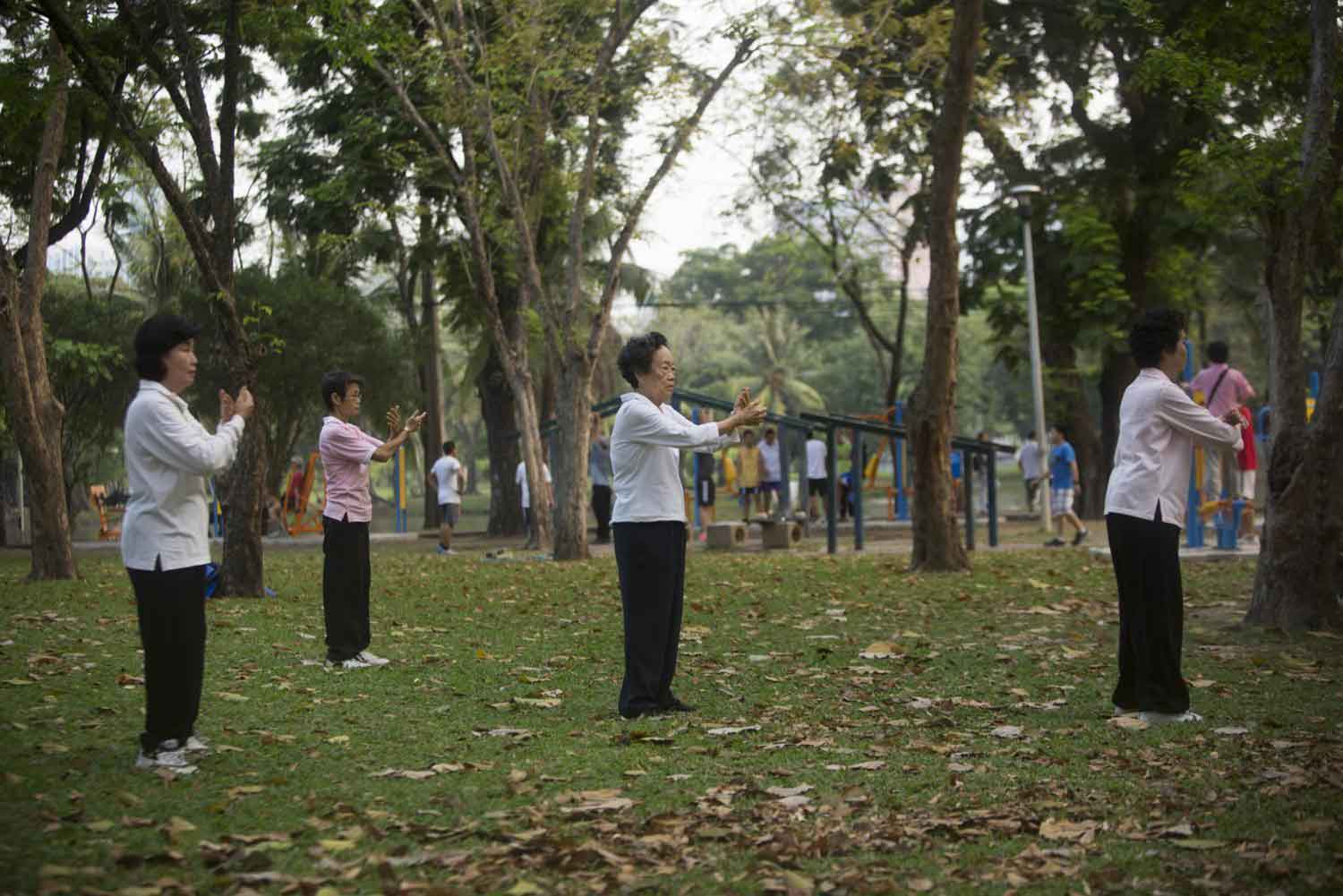 Women practice tai chi at Lumpini Park in Bangkok. (Photo: Bloomberg)