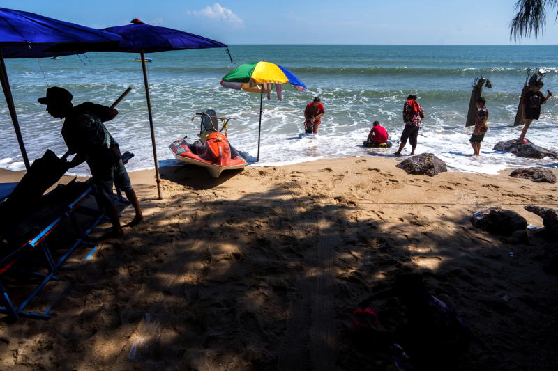 People enjoy Cha-am beach in Cha-am district of Phetchaburi province on Dec 25, 2021. (Reuters photo)